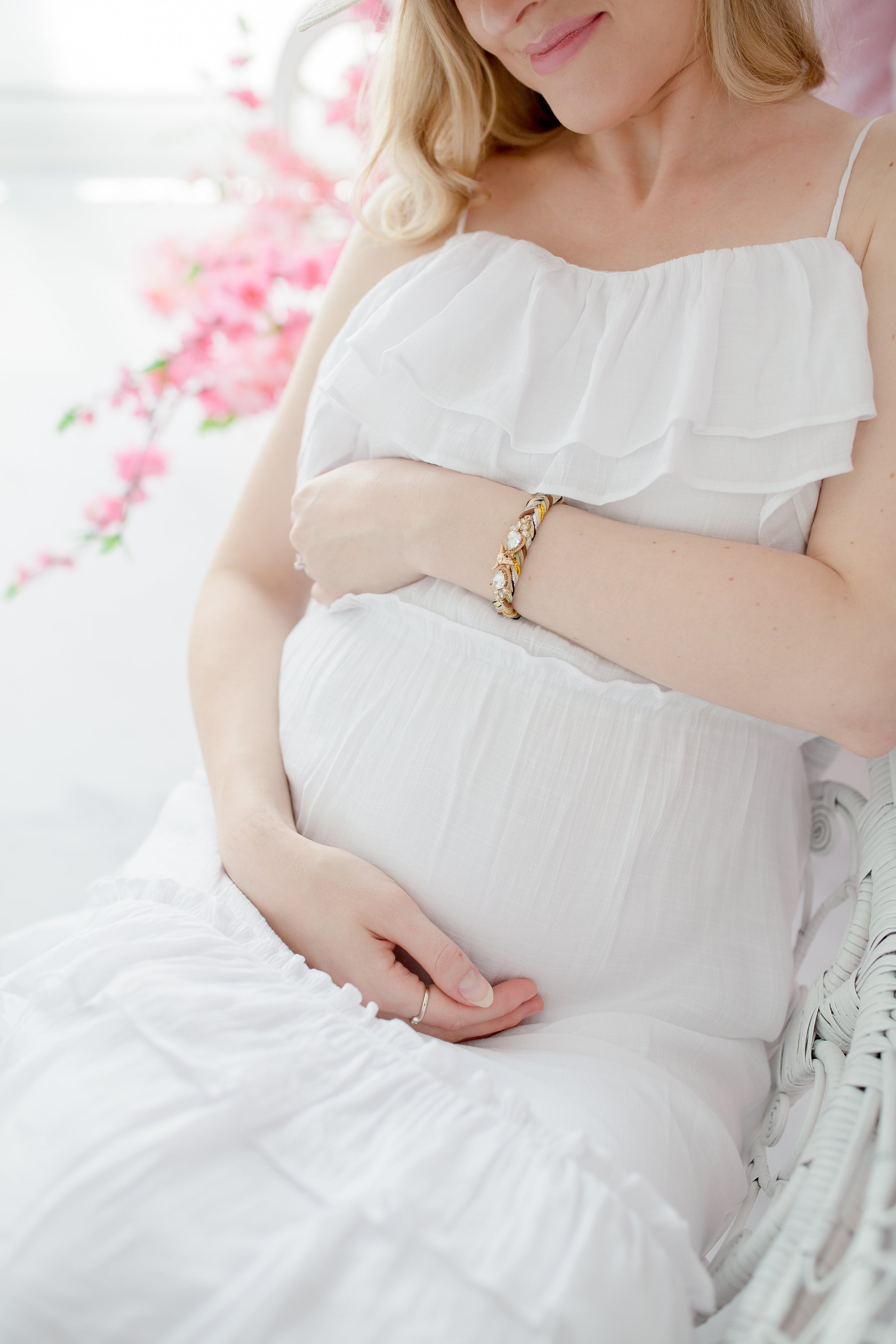files/woman-in-soft-white-dress-sits-and-holds-her-pregnant-belly.jpg